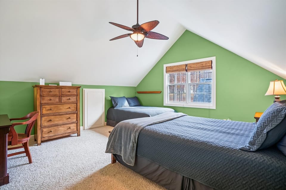 Loft with queen and full sized bed and workstation.