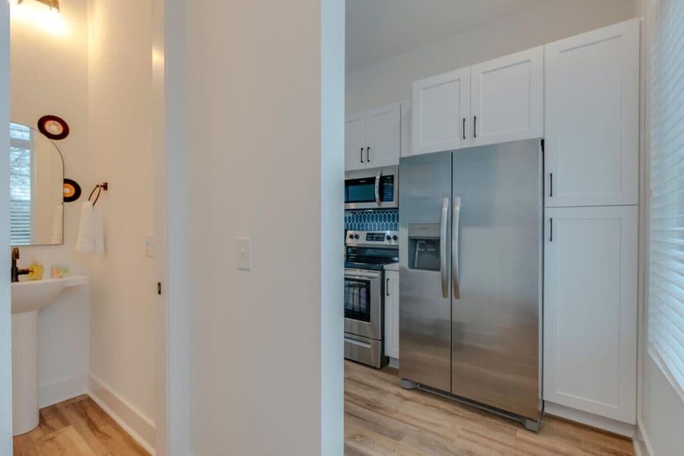 A hallway with a refrigerator nearby ensures easy snack access throughout the home.