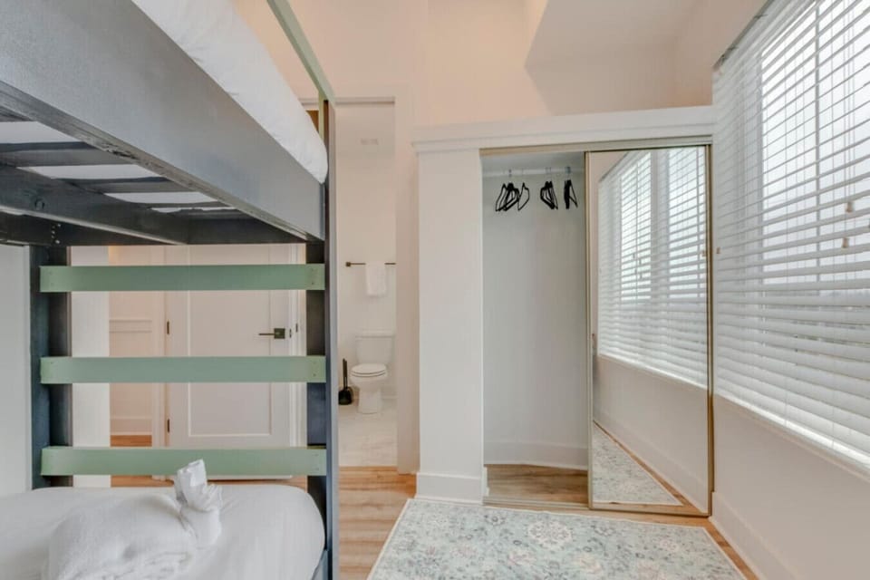 A bedroom with natural light and stacked frames makes efficient and comfortable use of the space.