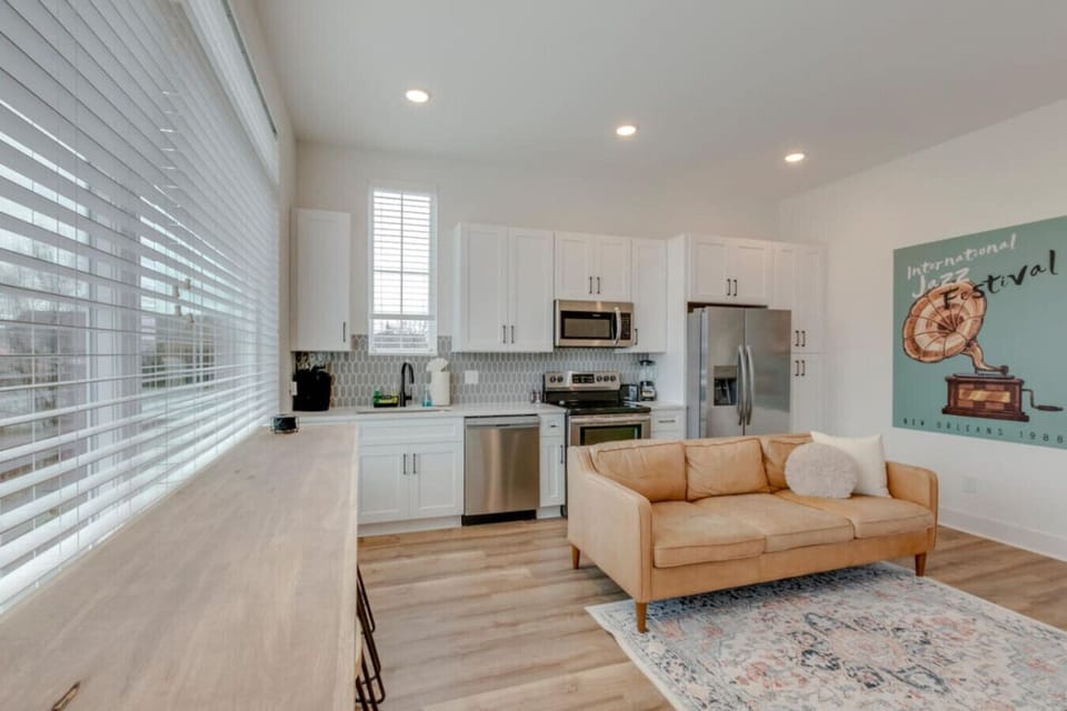 A living area with a large TV, blue cabinetry, and modern furnishings is perfect for group downtime.