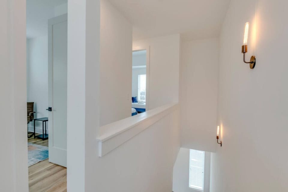 A bedroom with stylish decor and plenty of natural light is comfortable and well-appointed.
