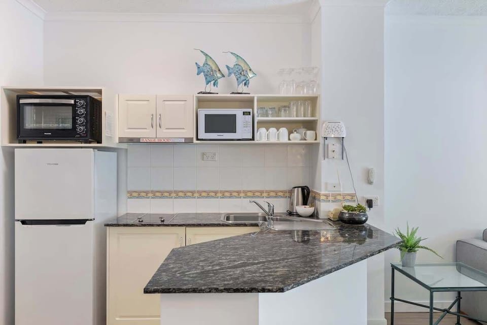 The kitchen is a charming area that has everything you need to get started on your own home creations. There is a microwave, benchtop oven, fridge, induction stove top and range hood. 
