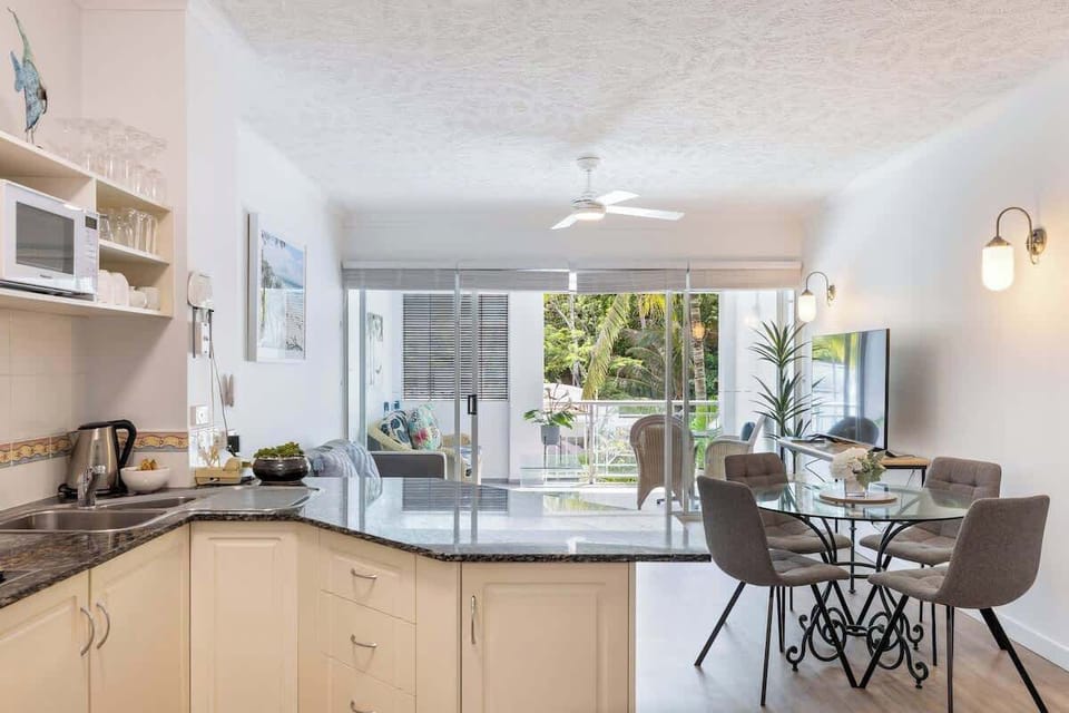 The dining nook is part of the open-plan apartment design, with an effortless flow with the living and kitchen areas. 
