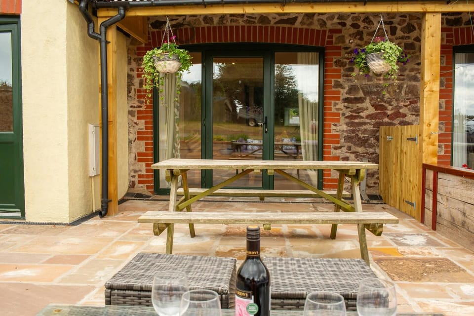 Patio with covered area over the patio doors leading to the cottage