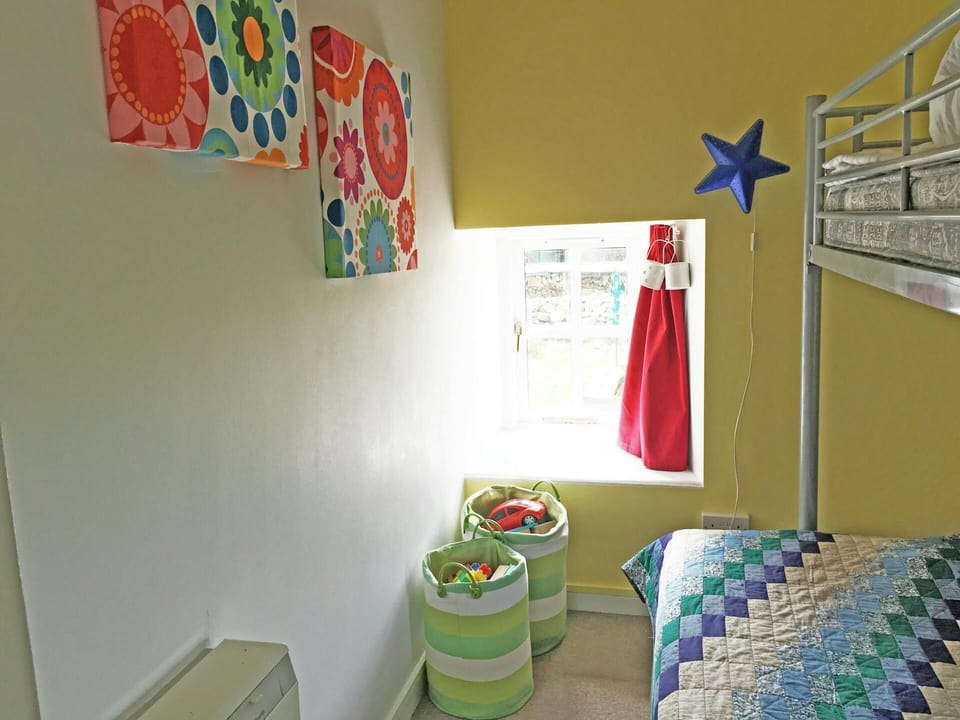 Bunk bedroom with double bed on the bottom and single bed on the top