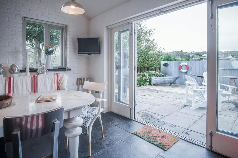 Patio doors leading to large furnished paved patio