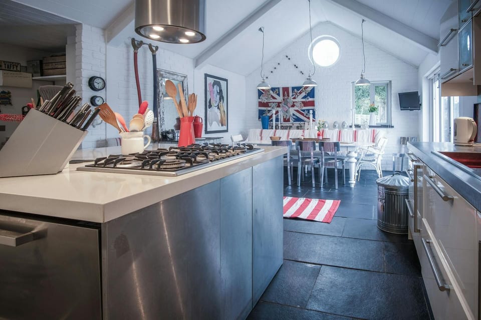 Tiled floor leading to a vaulted ceiling dining room