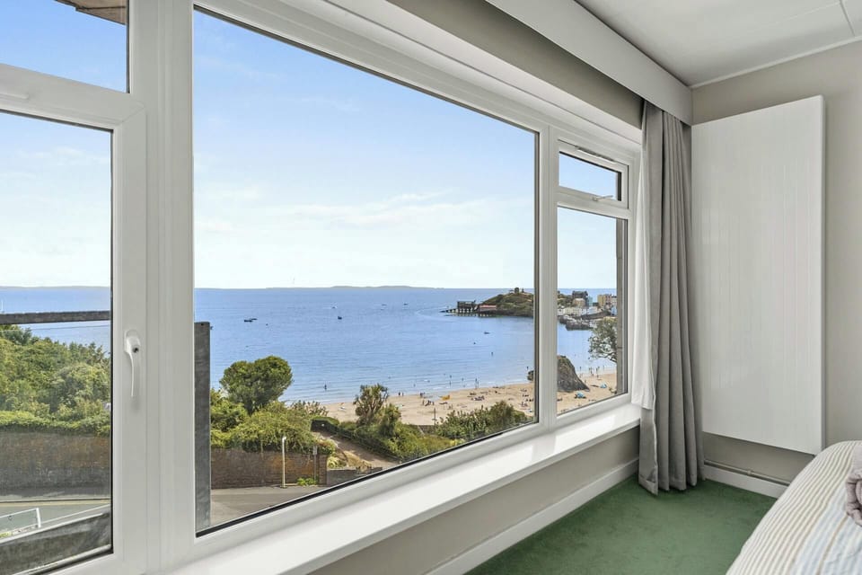 Sea and shoreline seen from indoors through a wide window