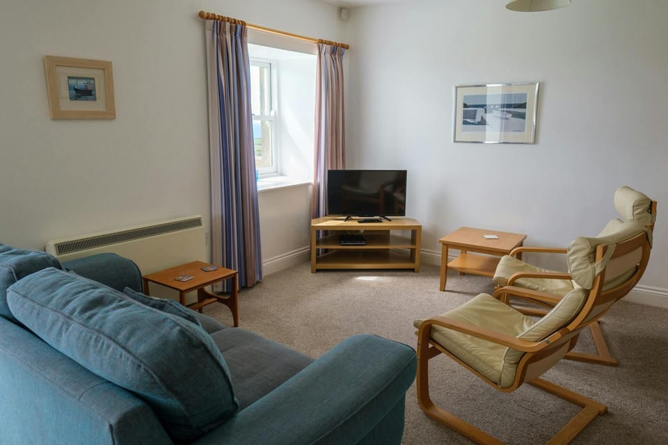 Sofa, armchairs, small tables and TV