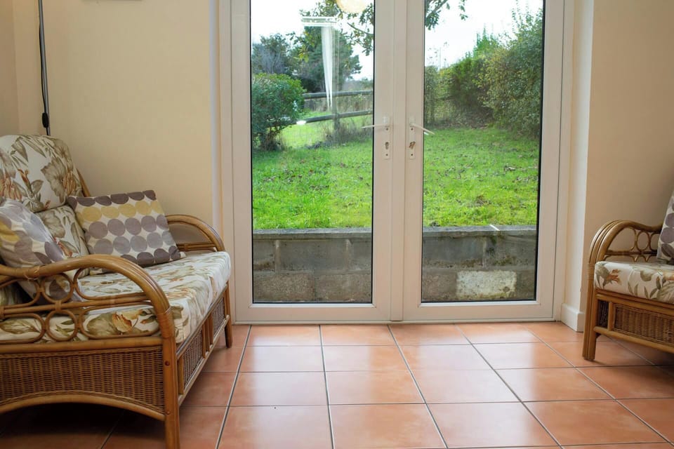 Double doors leading from the conservatory to the garden