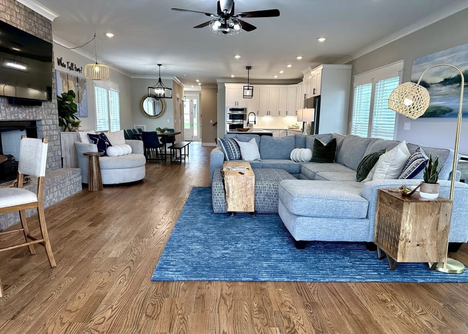Large living room with sectional, card/game table open to kitchen and porch