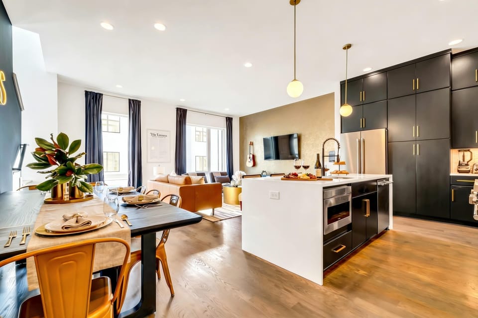 Open kitchen, dining, and living spaces flow together so the group stays connected for meals, games, and movie nights without splitting up