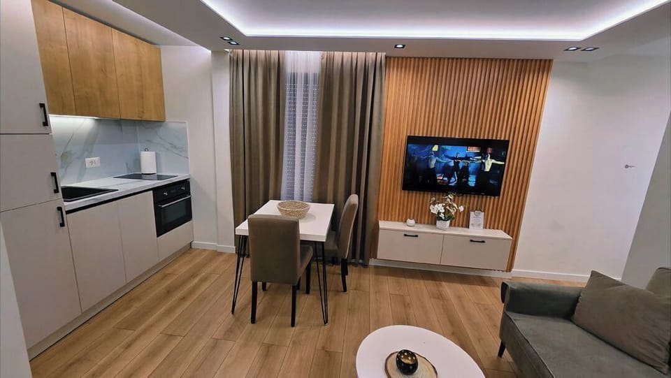 Deluxe Apartment | Living area | 42-inch flat-screen TV with cable channels