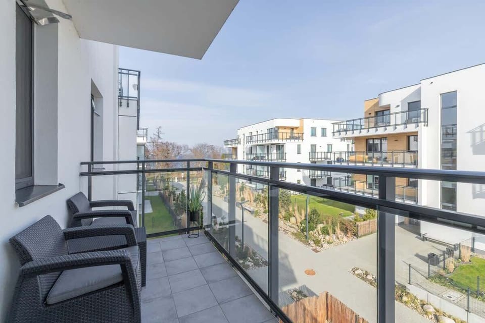 Sunny balcony overlooking the buildings, ideal for morning coffee.