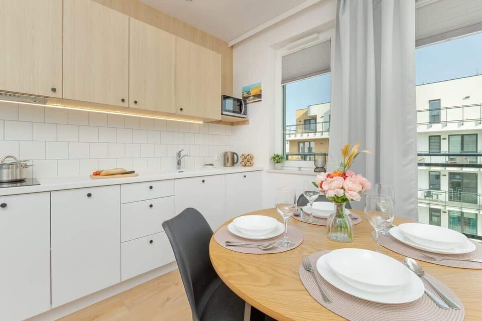 A modern kitchen with white cabinets and countertop where cooking becomes a pleasure.
