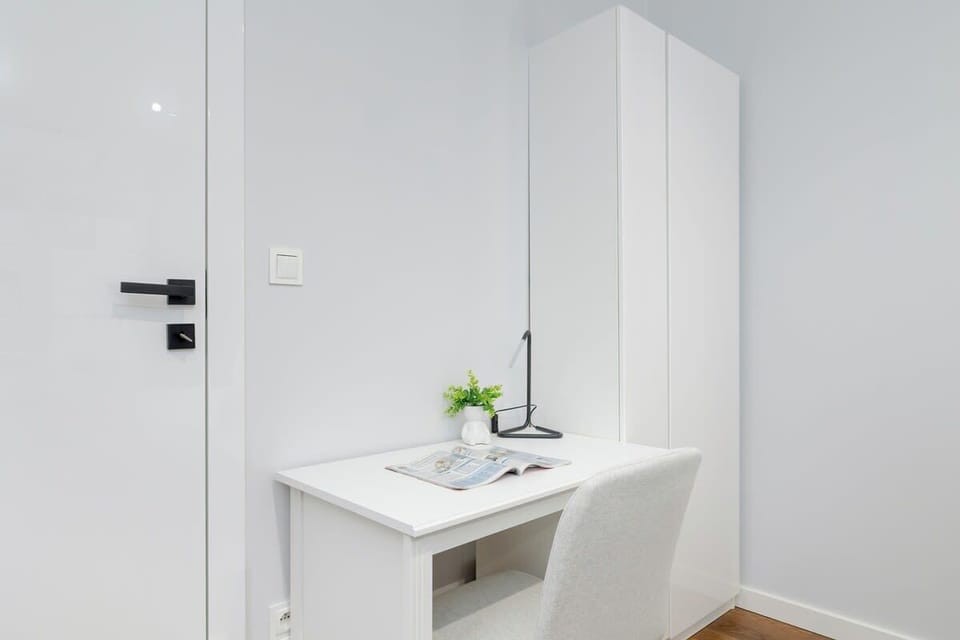 A desk with a comfy chair and a touch of greenery creates the perfect spot for work or makeup.