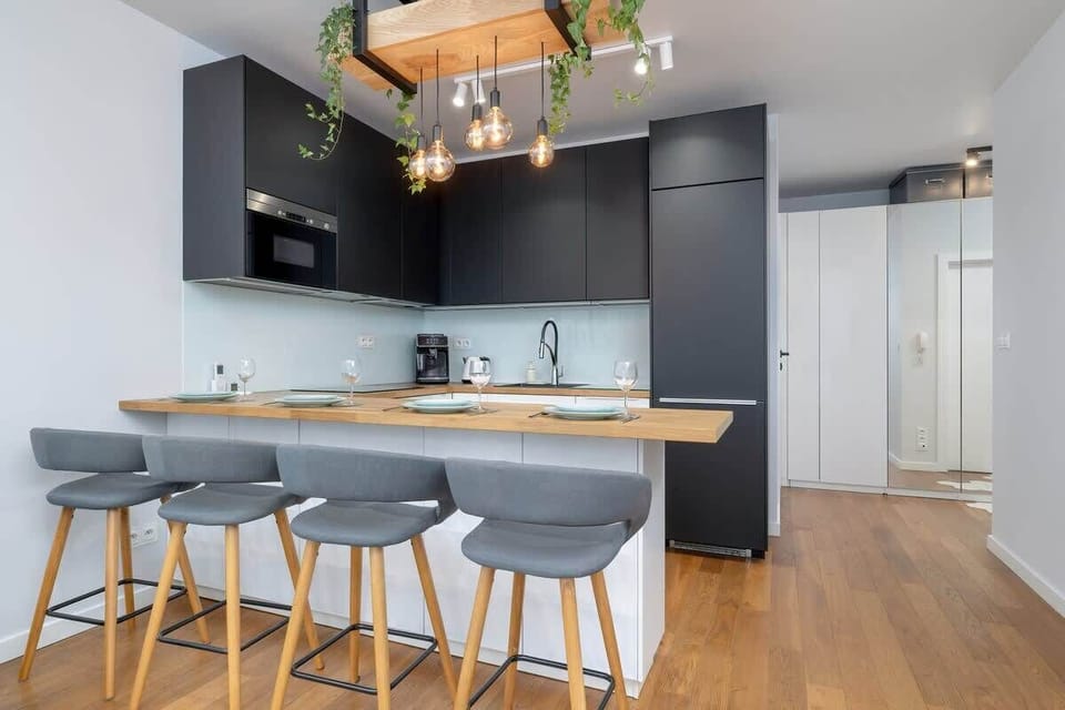 A sleek kitchen with an island and barstools combines functionality with inviting design.
