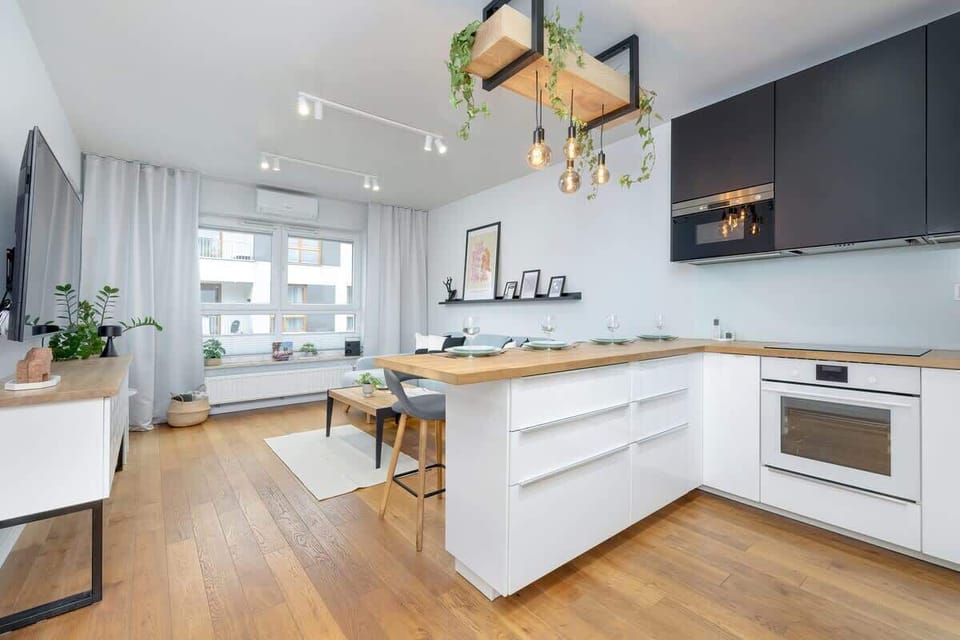 A modern kitchen with bright cabinetry and open space encourages shared cooking and conversation.