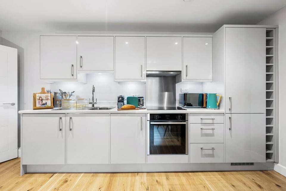 Whip up a home-cooked meal with family in the fully equipped kitchen and dining area at Blue Puffin Stays  Short Lets & Serviced Accommodation