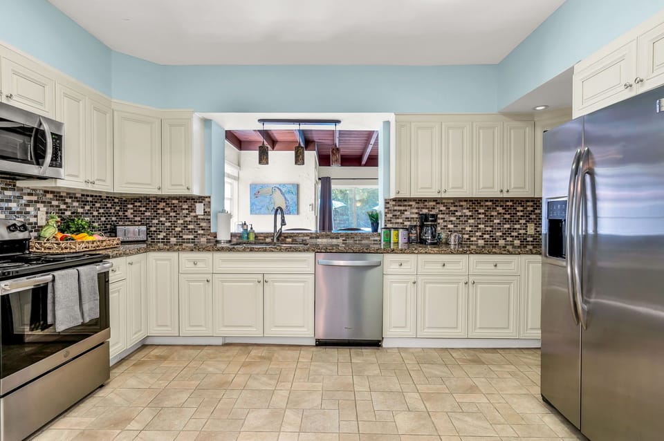 Prepare to unleash your culinary creativity in this fully-equipped kitchen! Stocked with indoor and outdoor dining sets, an array of cooking utensils, bakeware, and a variety of appliances including a blender, toaster, microwave, and more.