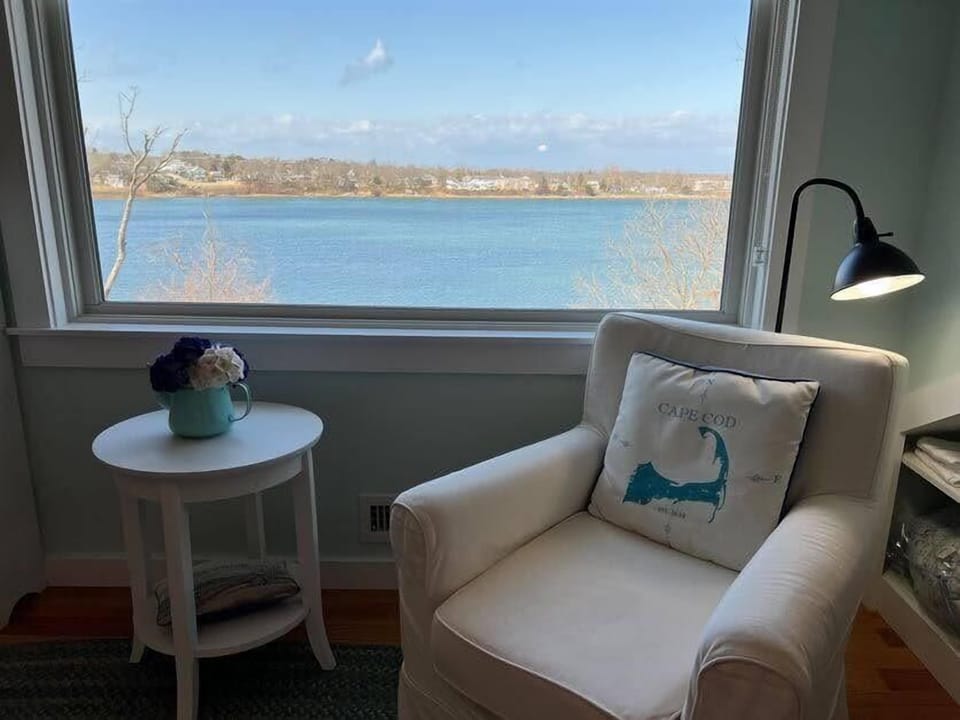 Primary bedroom sitting area with water views