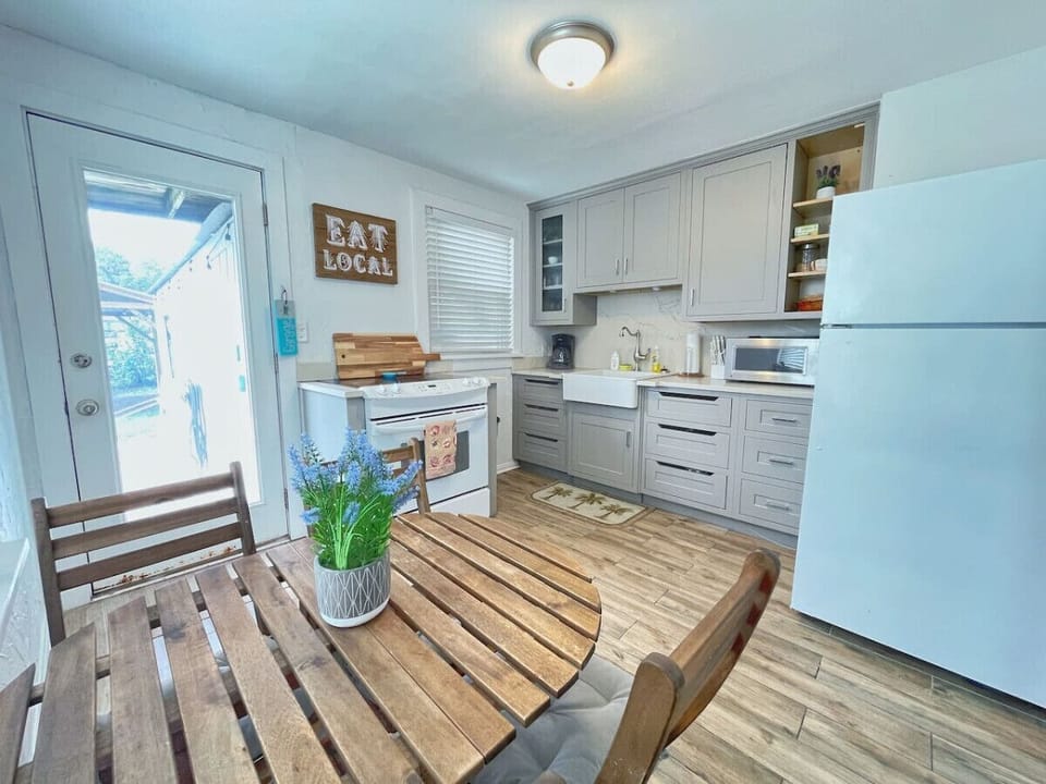 Custom quartz counter top kitchen with a farmhouse sink is located in the downstairs unit.