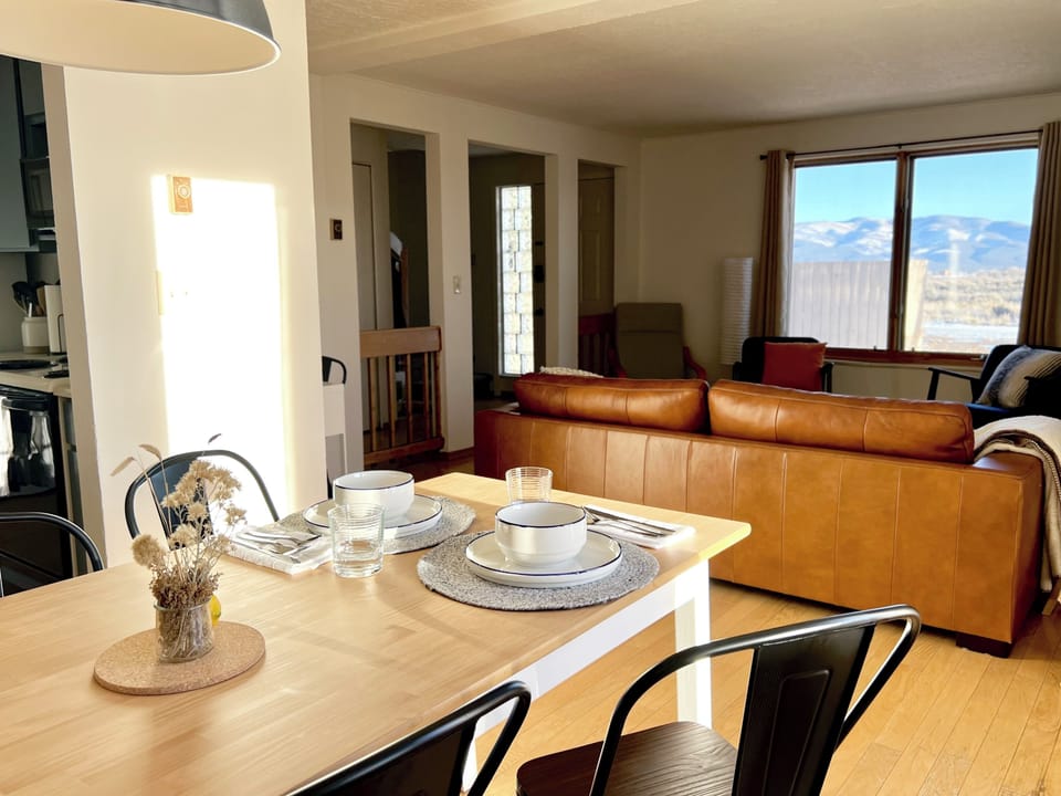 Open-concept living and dining space with mountain views