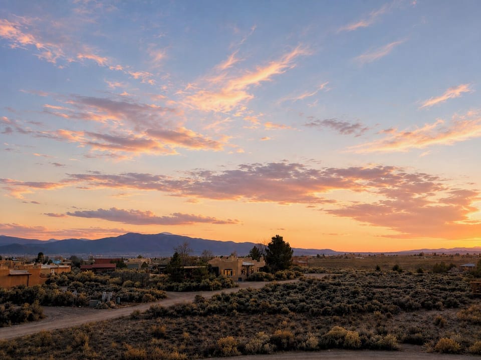 Stunning desert sunset views with open skies and mountain backdrop from the master suite