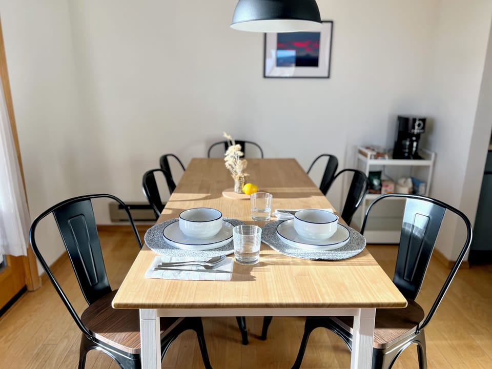 Bright modern dining area with seating for eight and coffee station