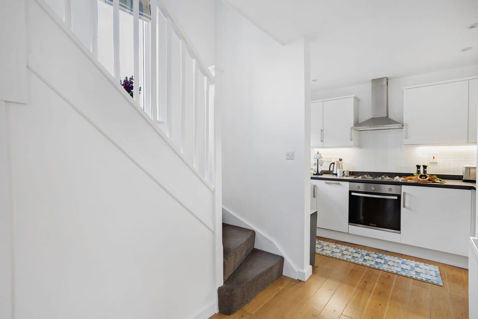 Kitchen and stairs leading to sleeping area and bathroom - Vickery's Cottage