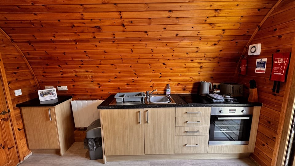 Kitchenette with oven, hob, toaster, kettle and fridge with freezer compartment