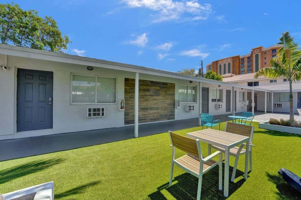 Exterior lawn with outdoor dining and unit entry