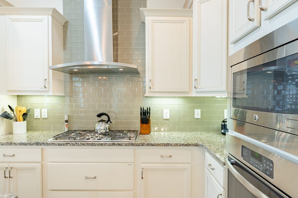 Kitchen is fully equipped and features stainless steel appliances.