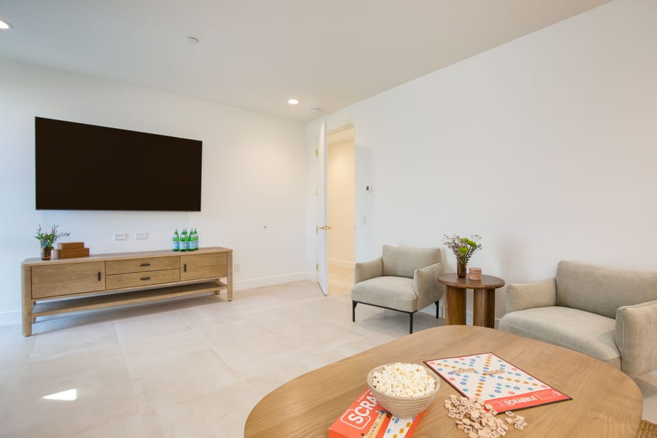 The media room features a large flatscreen TV.