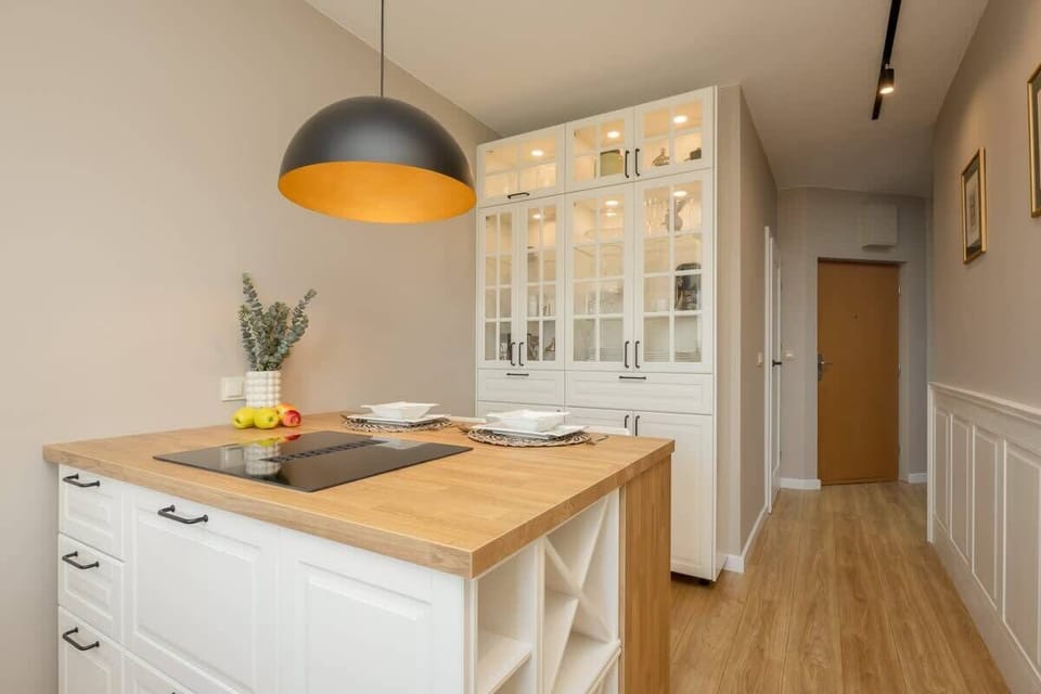 View of the kitchen space with hanging lamps and a modern design.