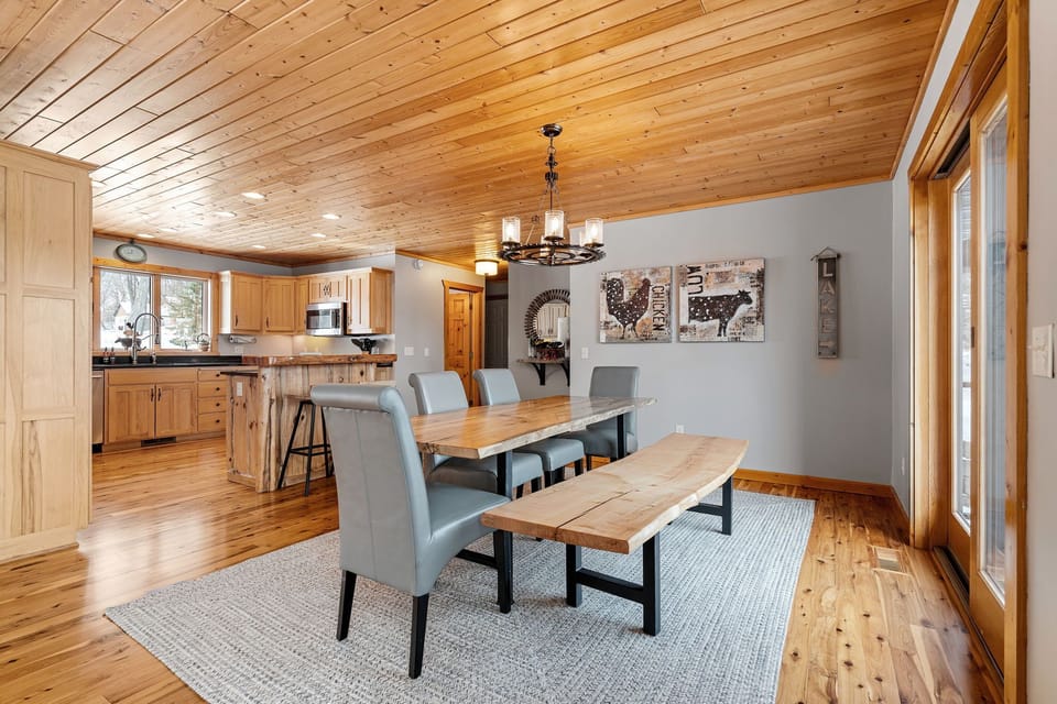 Gather around this rustic dining table where your group can share meals beneath warm wood beams and charming farmhouse decor.