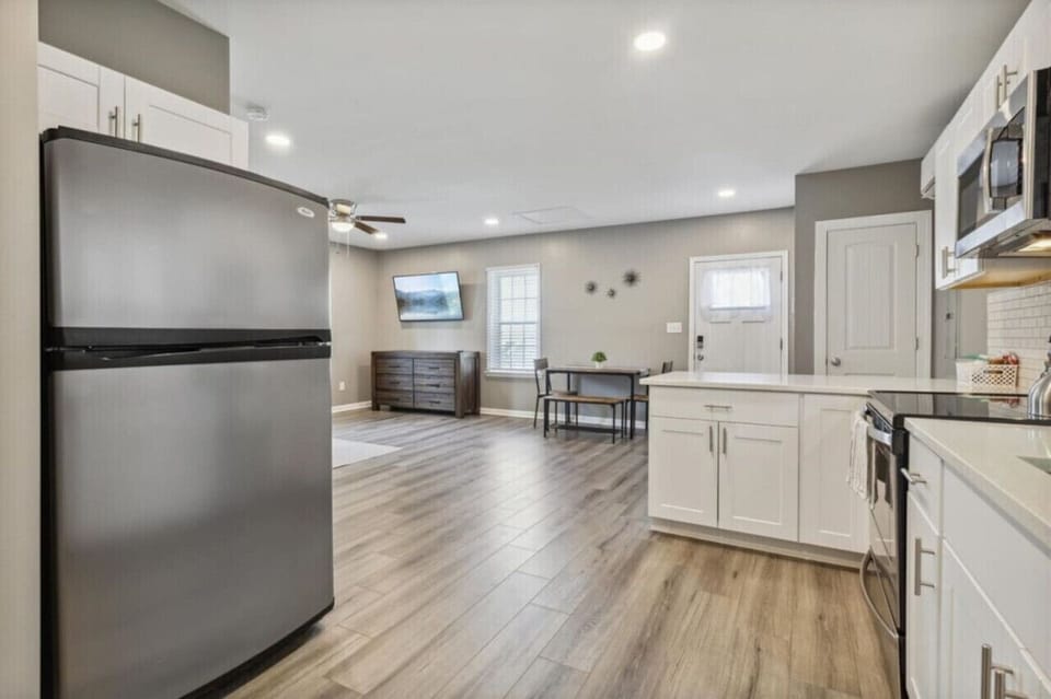 The kitchen is fully stocked with all the appliances, including the laundry facilities located next to the refrigerator.