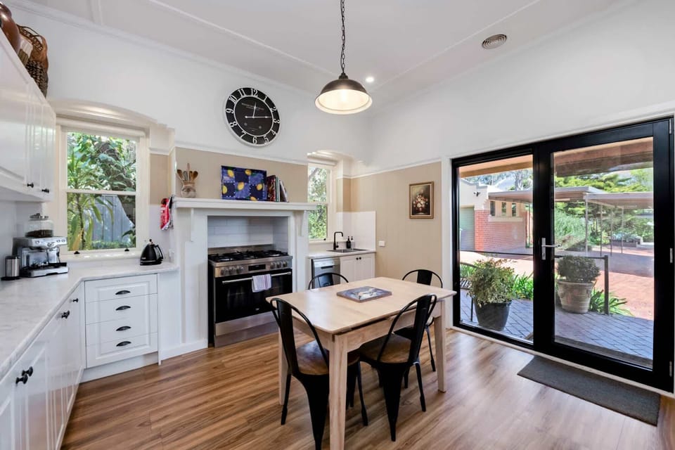 Dining room and full kitchen with fridge, oven, dishwasher and more.