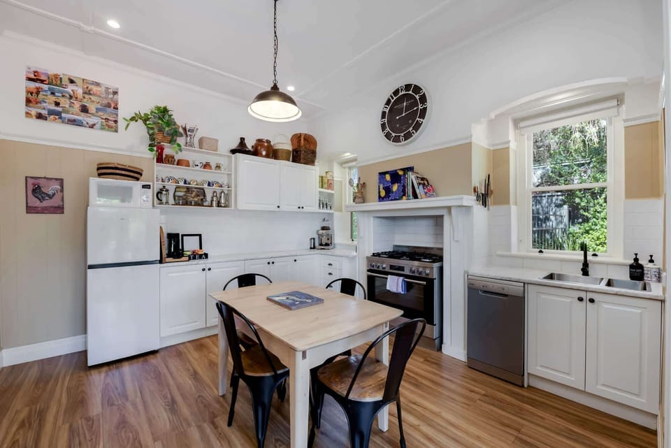 Dining room and full kitchen with fridge, oven, dishwasher and more.