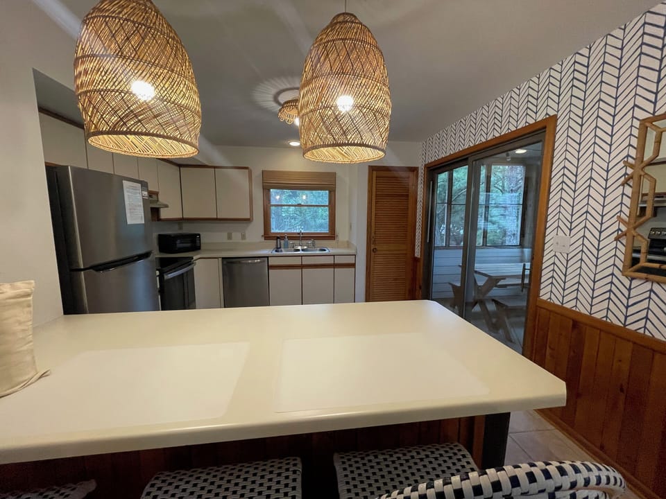 Kitchen with pantry door and door to screened porch