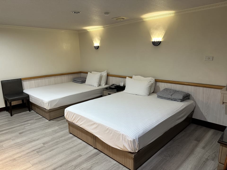 Business Quadruple Room | Living area | 32-inch LCD TV with cable channels
