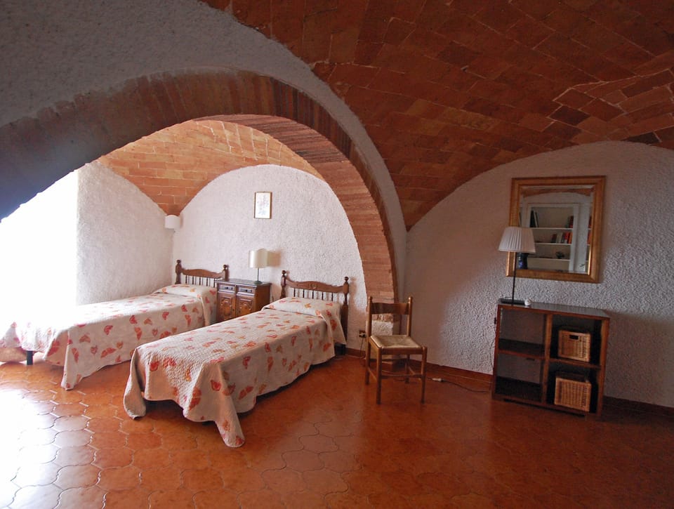 The twin bedroom has brick vaulted ceilings