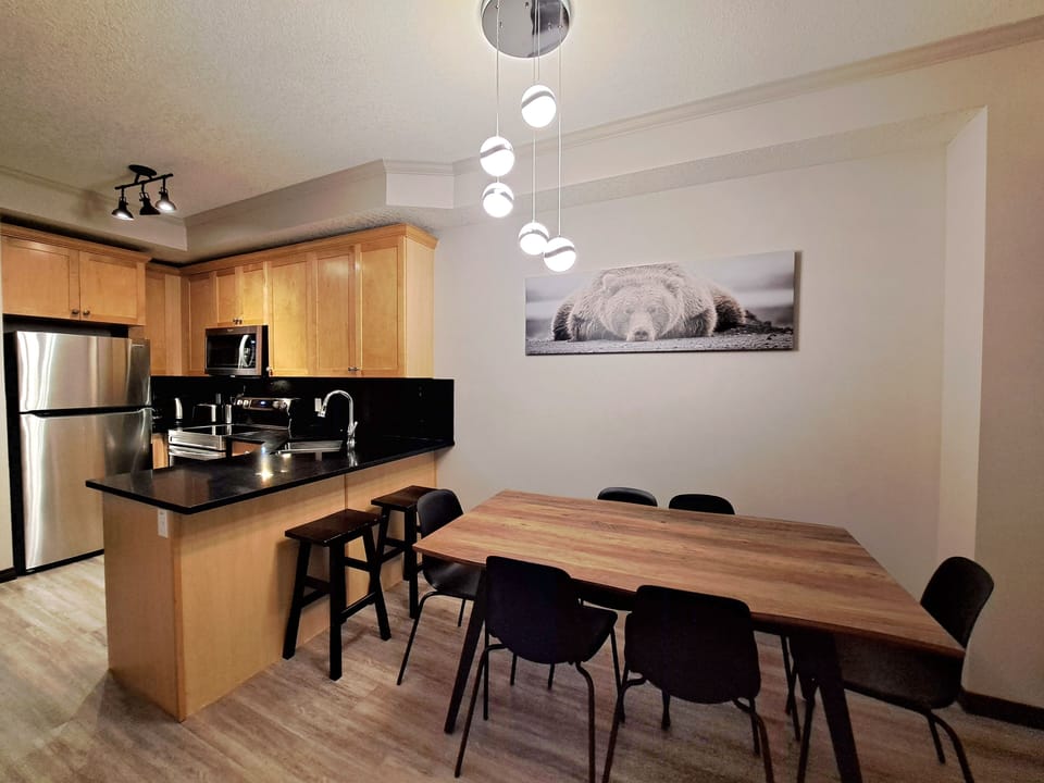 Kitchen table seats 6 with 2 extra spots at the bar stools!