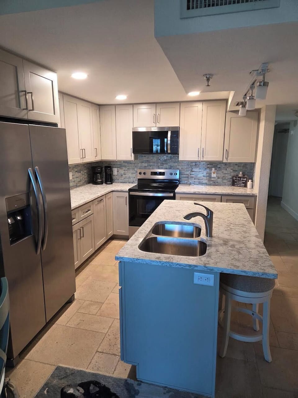 Quartz countertops, new cupboards, and colorful backsplash.