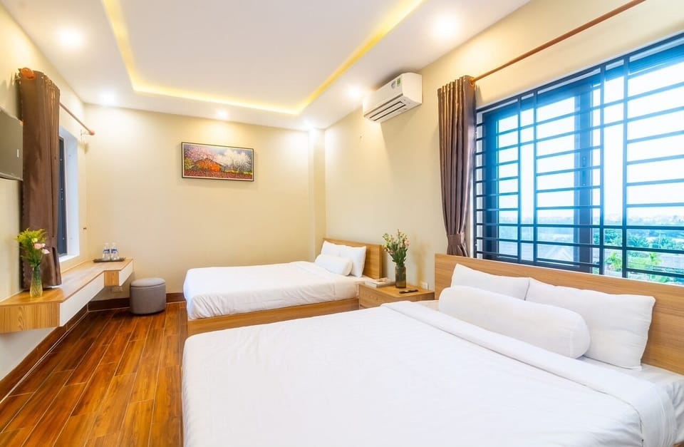 Deluxe Quadruple Room | Down comforters, desk, laptop workspace, soundproofing