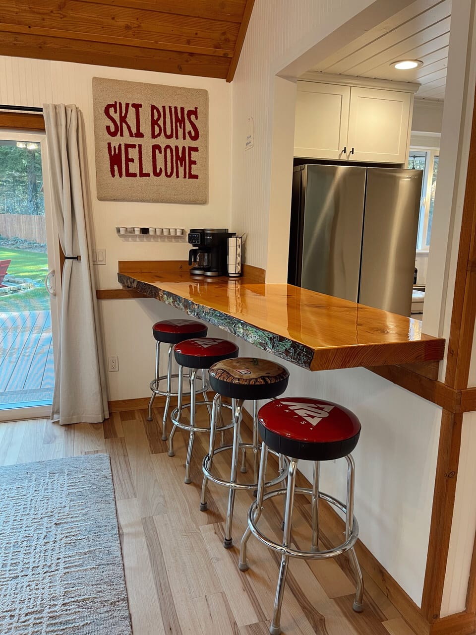 Live edge breakfast bar with seating. Keurig coffee machine with assort. of pods