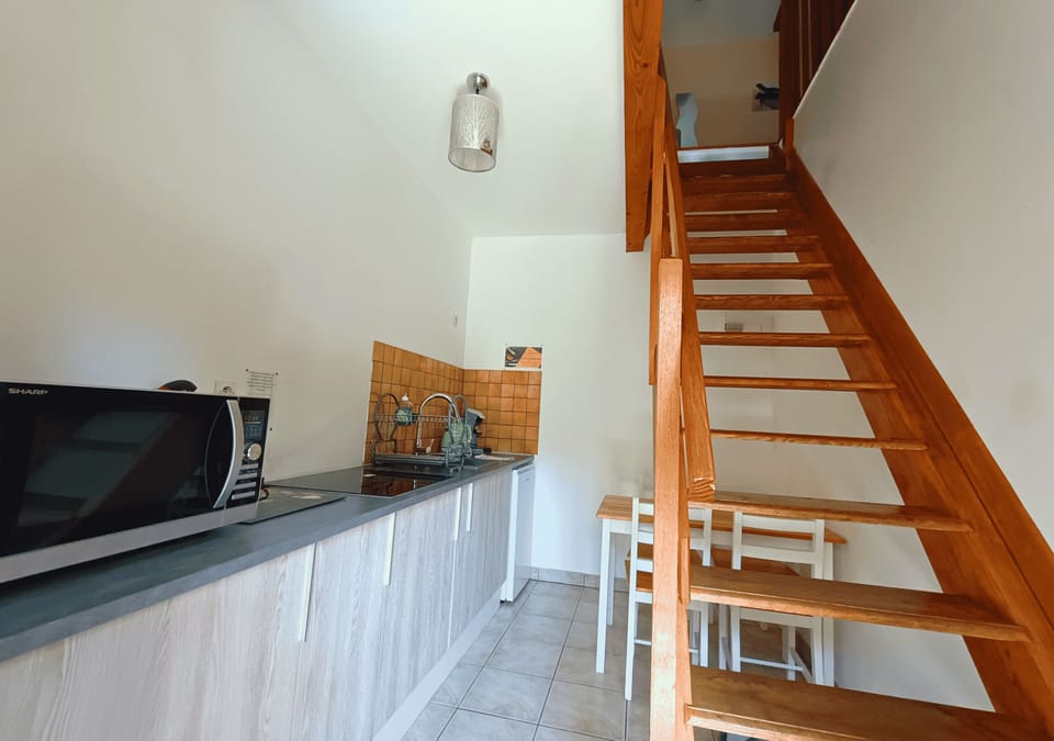 Family Studio, Multiple Beds, Non Smoking, Garden View | Private kitchen | Electric kettle, highchair, dining table
