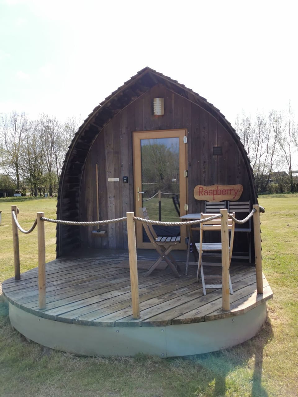 Raspberry glamping pod with outside seating area