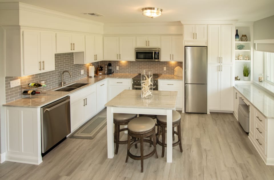 Fully equipped kitchen, dining with seating for 4, desk with chair, marina view