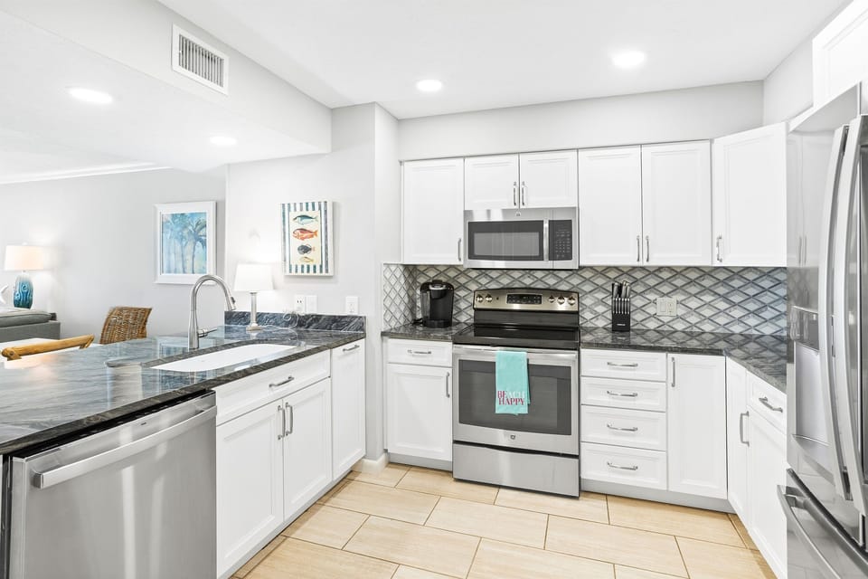 Your fully-equipped kitchen awaits with granite countertops, stainless appliances, and modern fixtures perfect for preparing memorable vacation meals together.